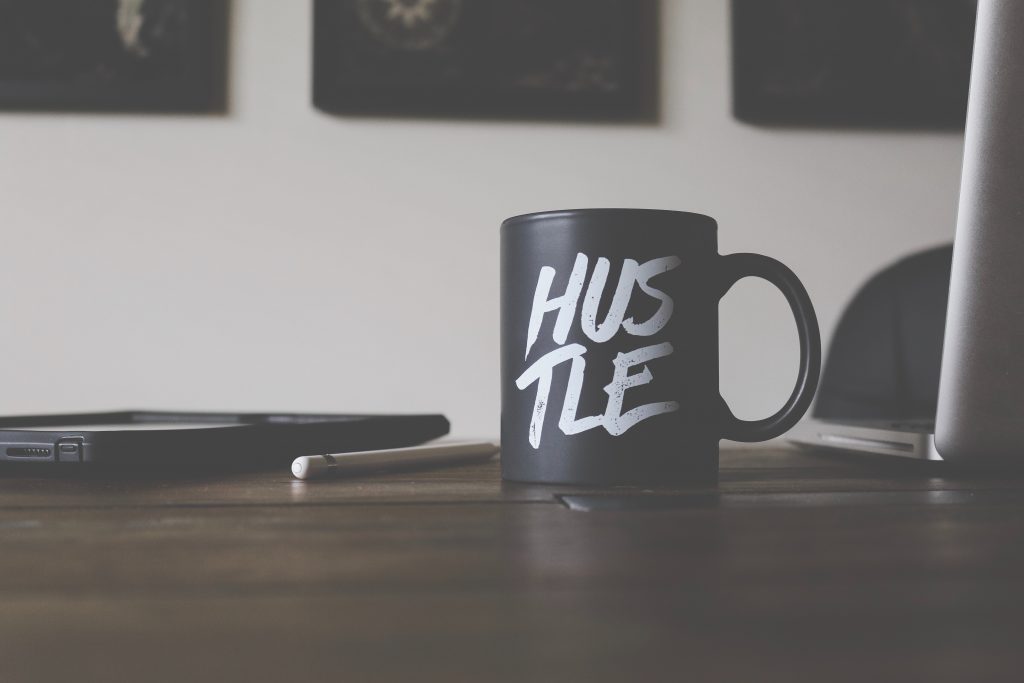 coffee mug that says hustle on it
